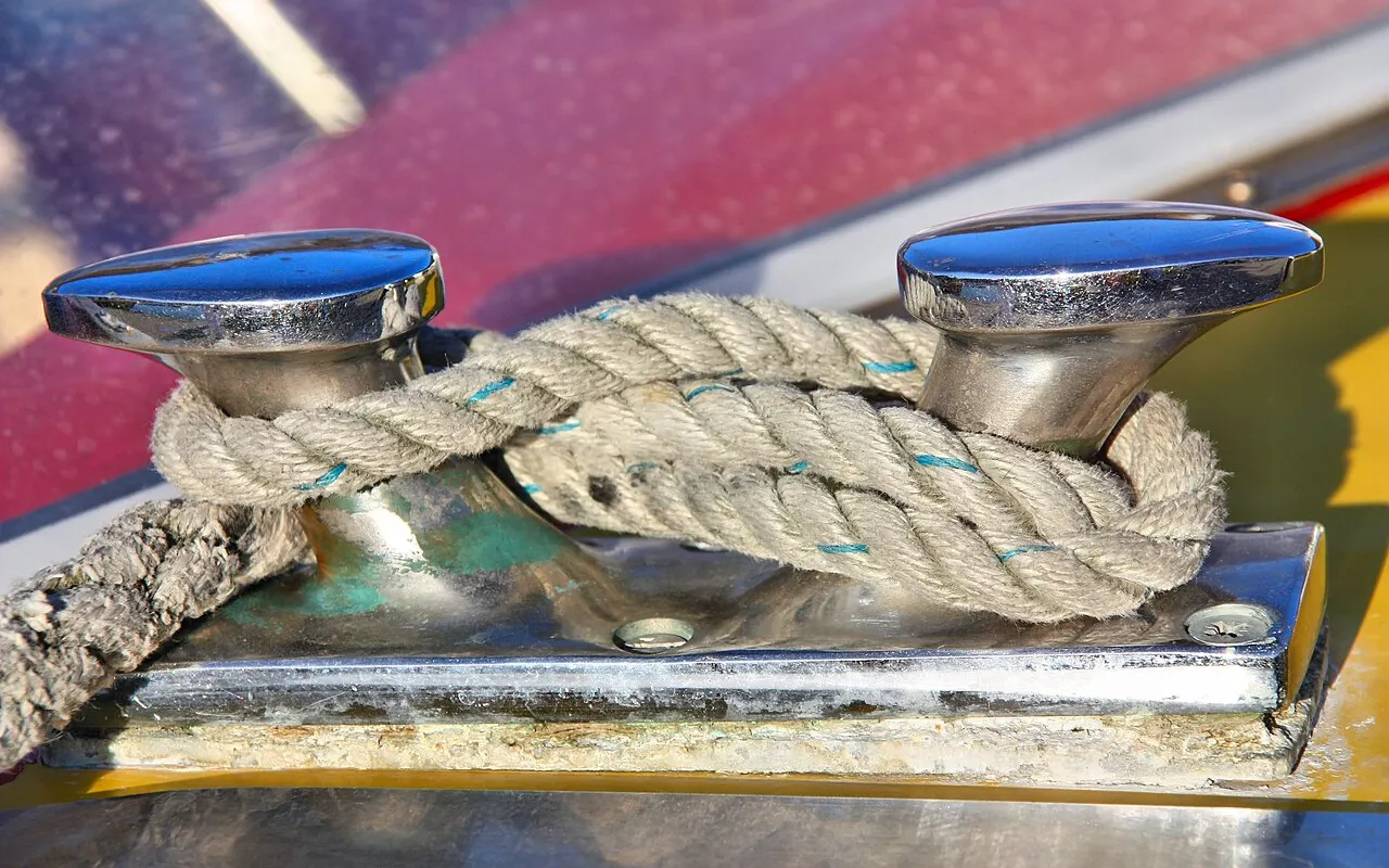 A mooring rope made fast to a chrome deck cleat with a cleat hitch