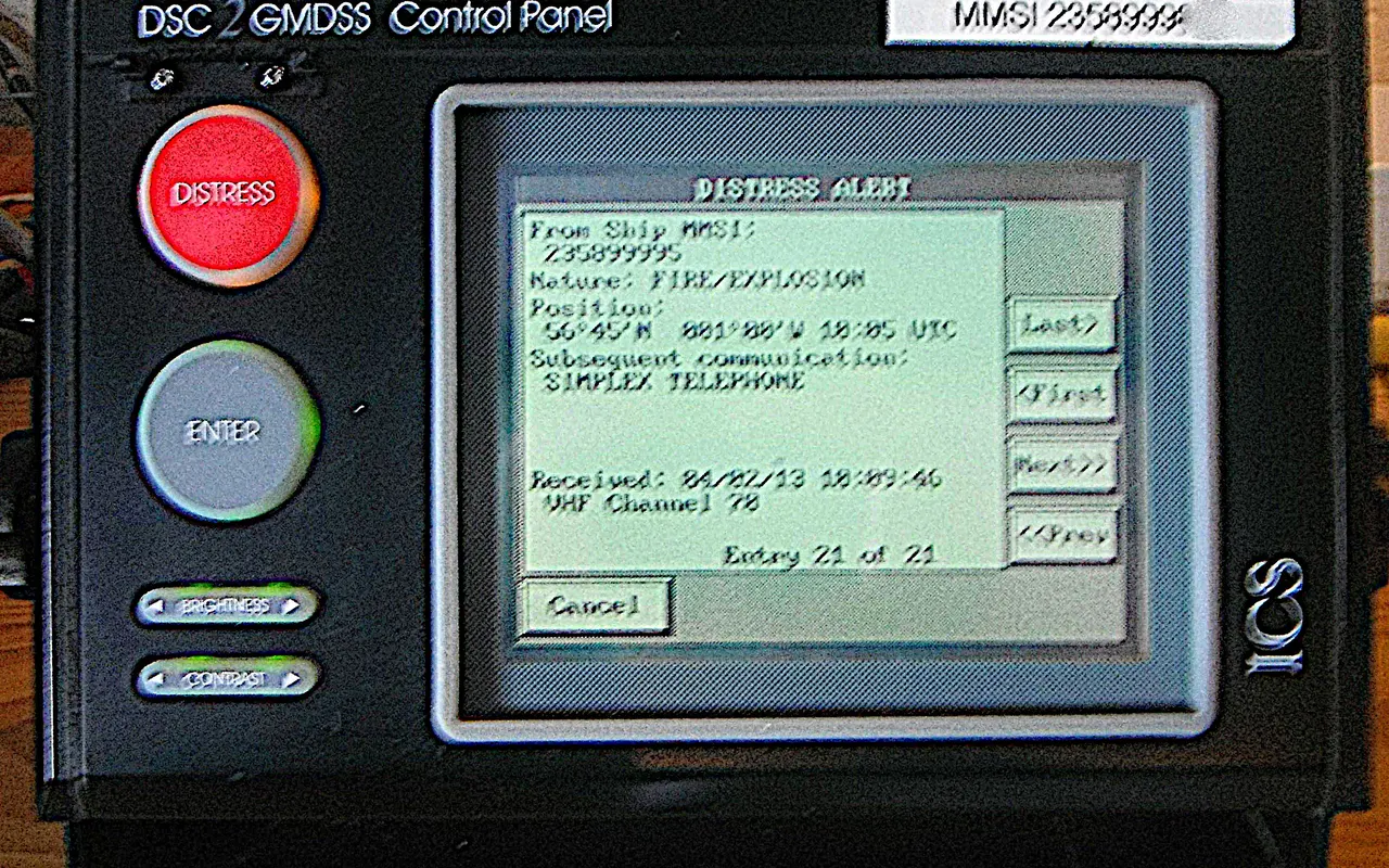 A DSC control panel with a red distress button and a screen showing a received distress alert