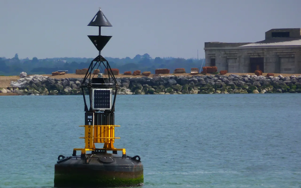 An east cardinal buoy, black-yellow-black with its cones pointing apart