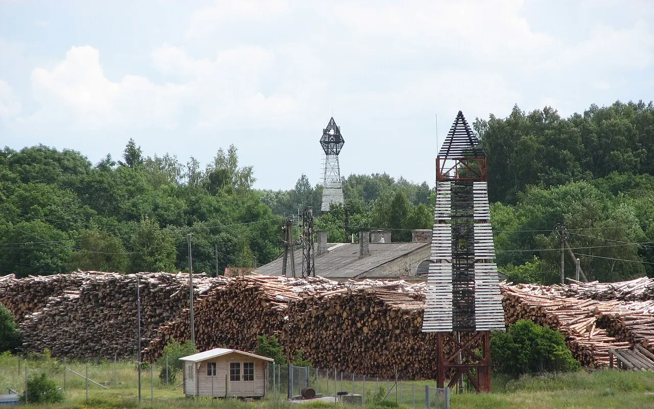 Two leading-mark towers, a front and a taller rear, standing among trees