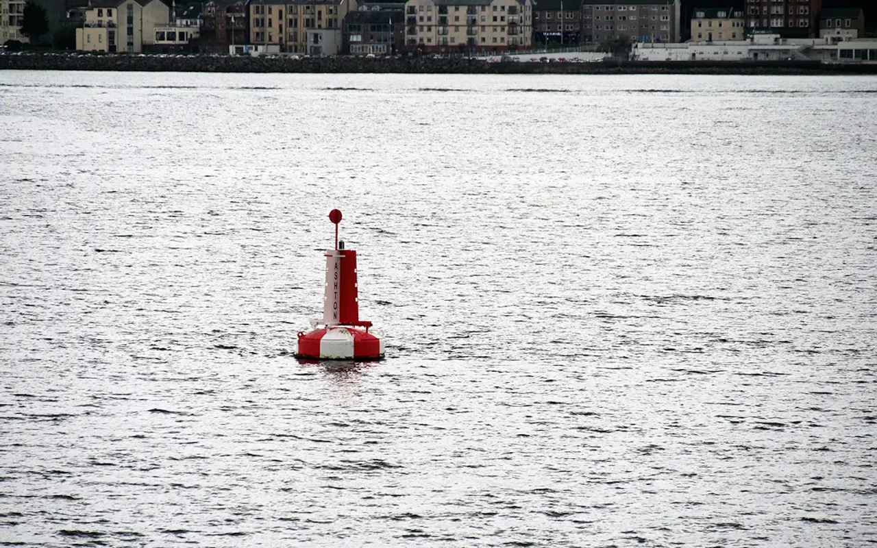 A red and white safe water buoy in the Firth of Clyde