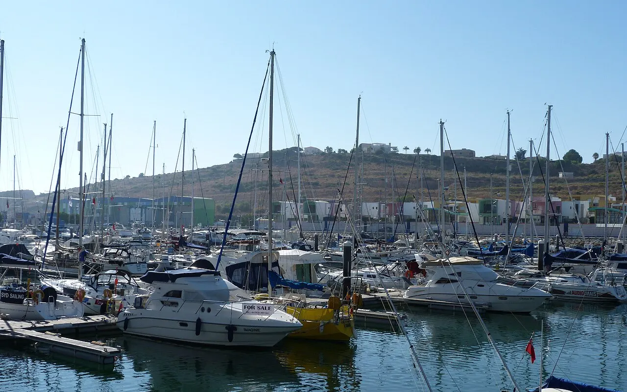 A marina with rows of finger pontoons and moored motor boats and yachts