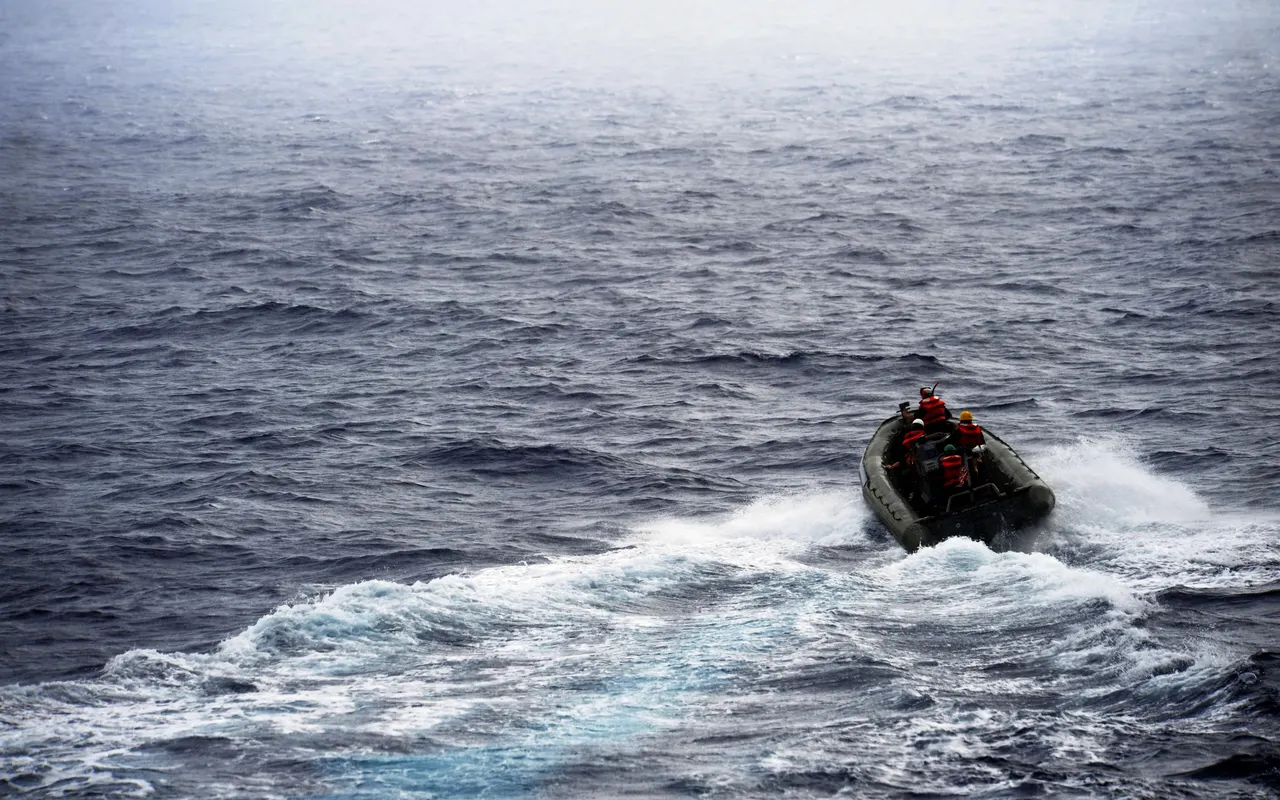 A rigid inflatable boat speeding across open sea during a man overboard drill