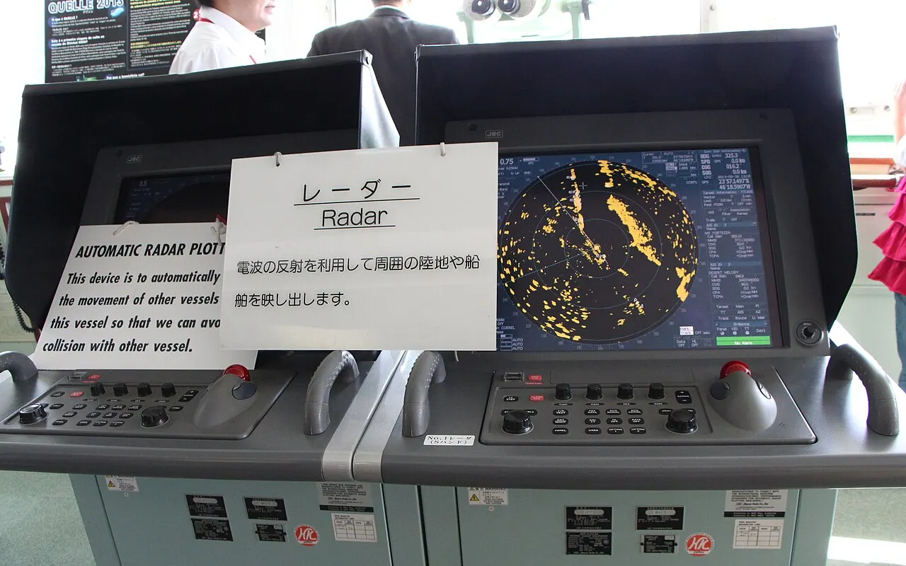 A ship's ARPA radar display on a bridge console showing echoes