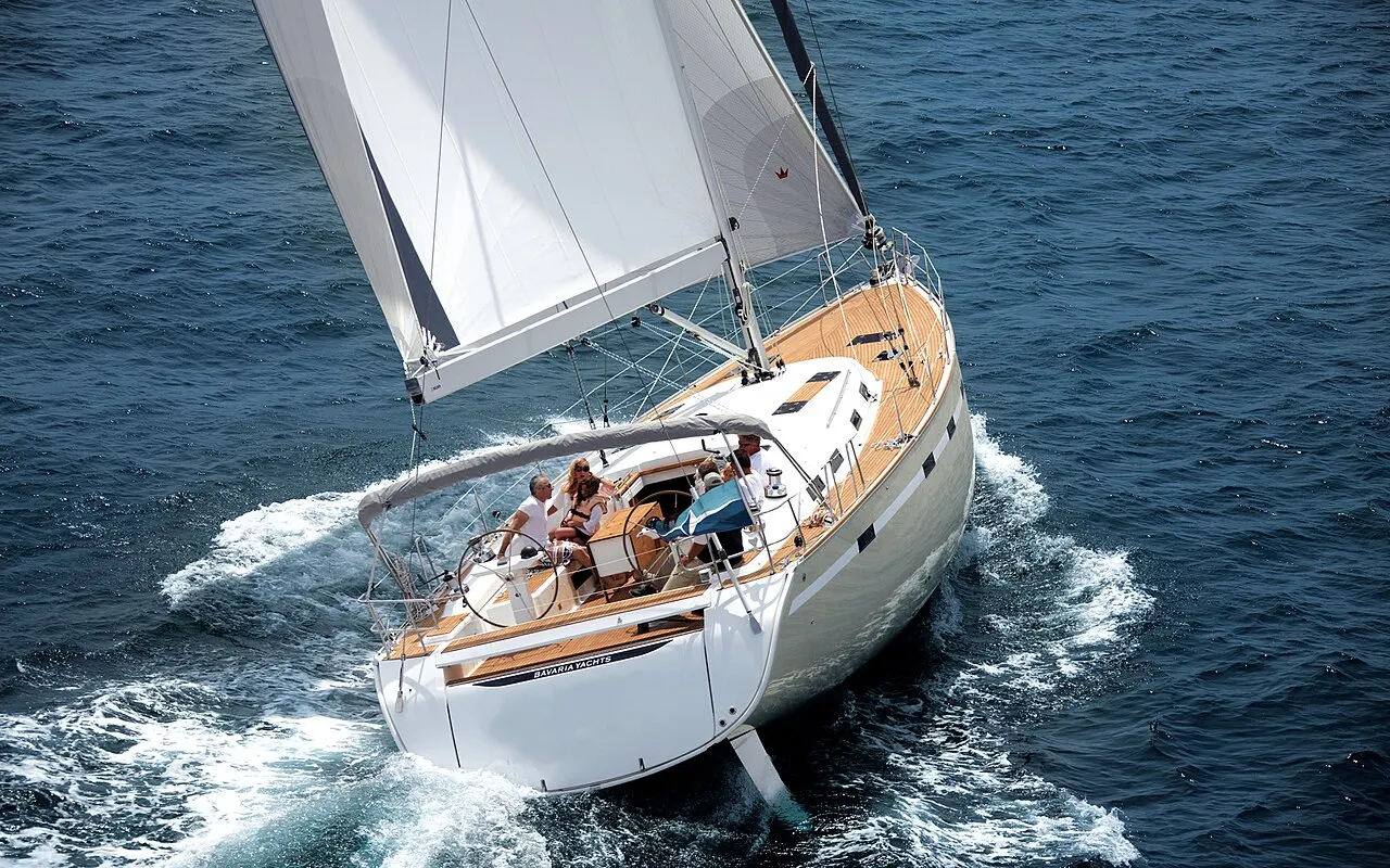 A large cruising yacht sailing upwind, heeled over with sails sheeted in tight