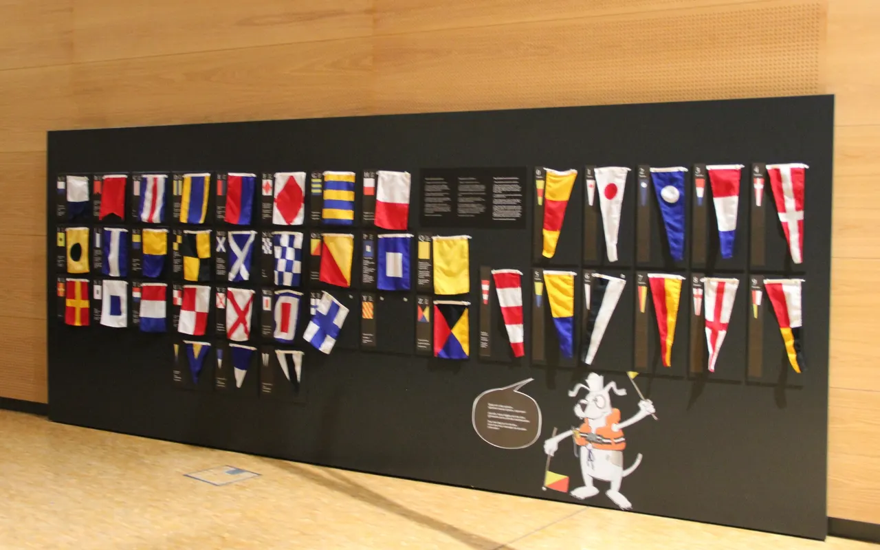 A museum display of international maritime signal flags with their letters