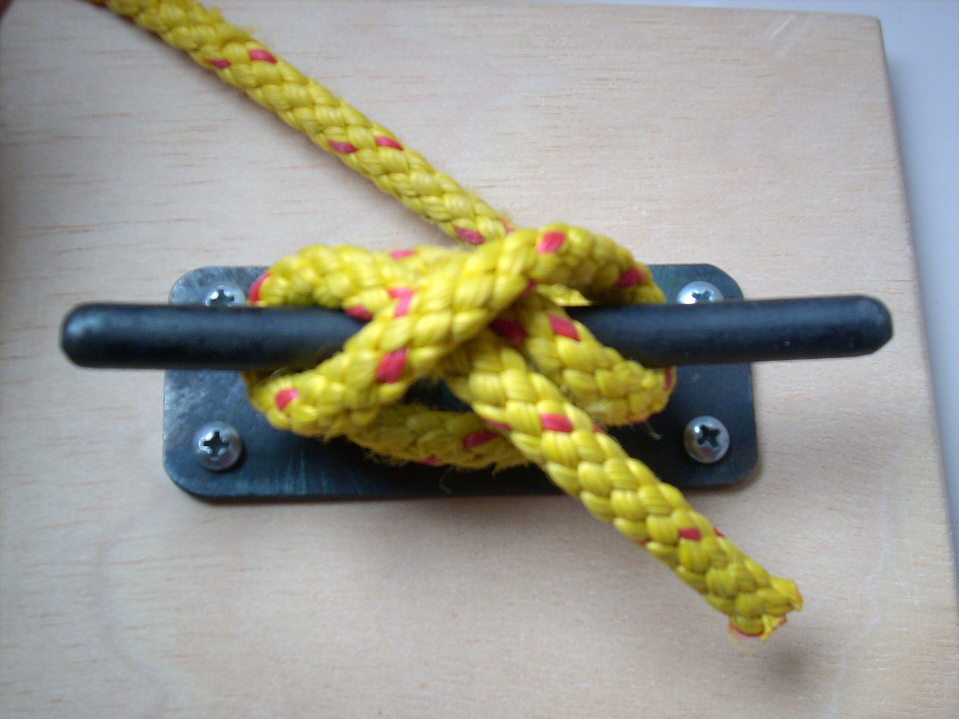 Yellow rope made fast on a deck cleat
