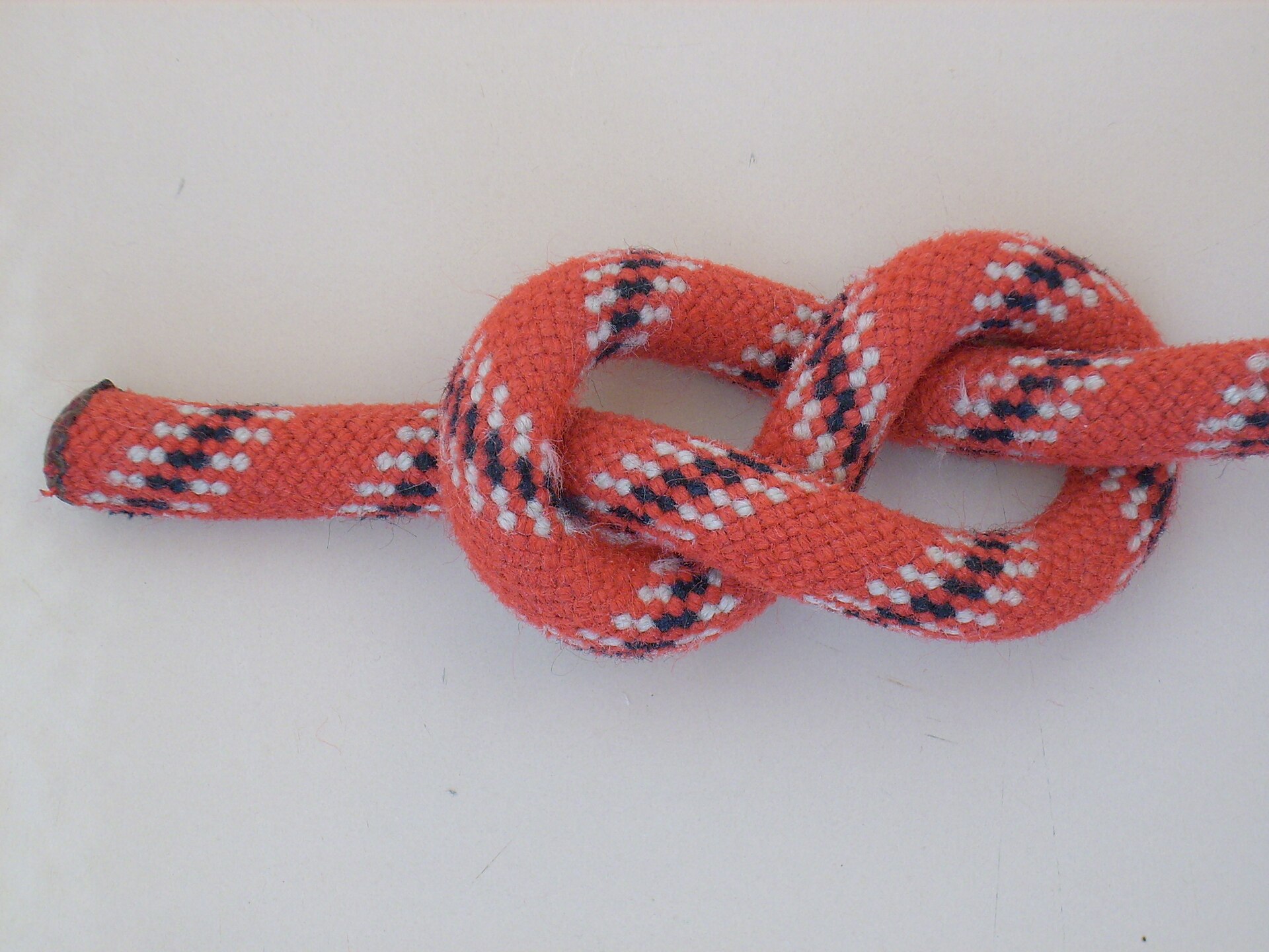 A finished figure-eight knot tied in red rope