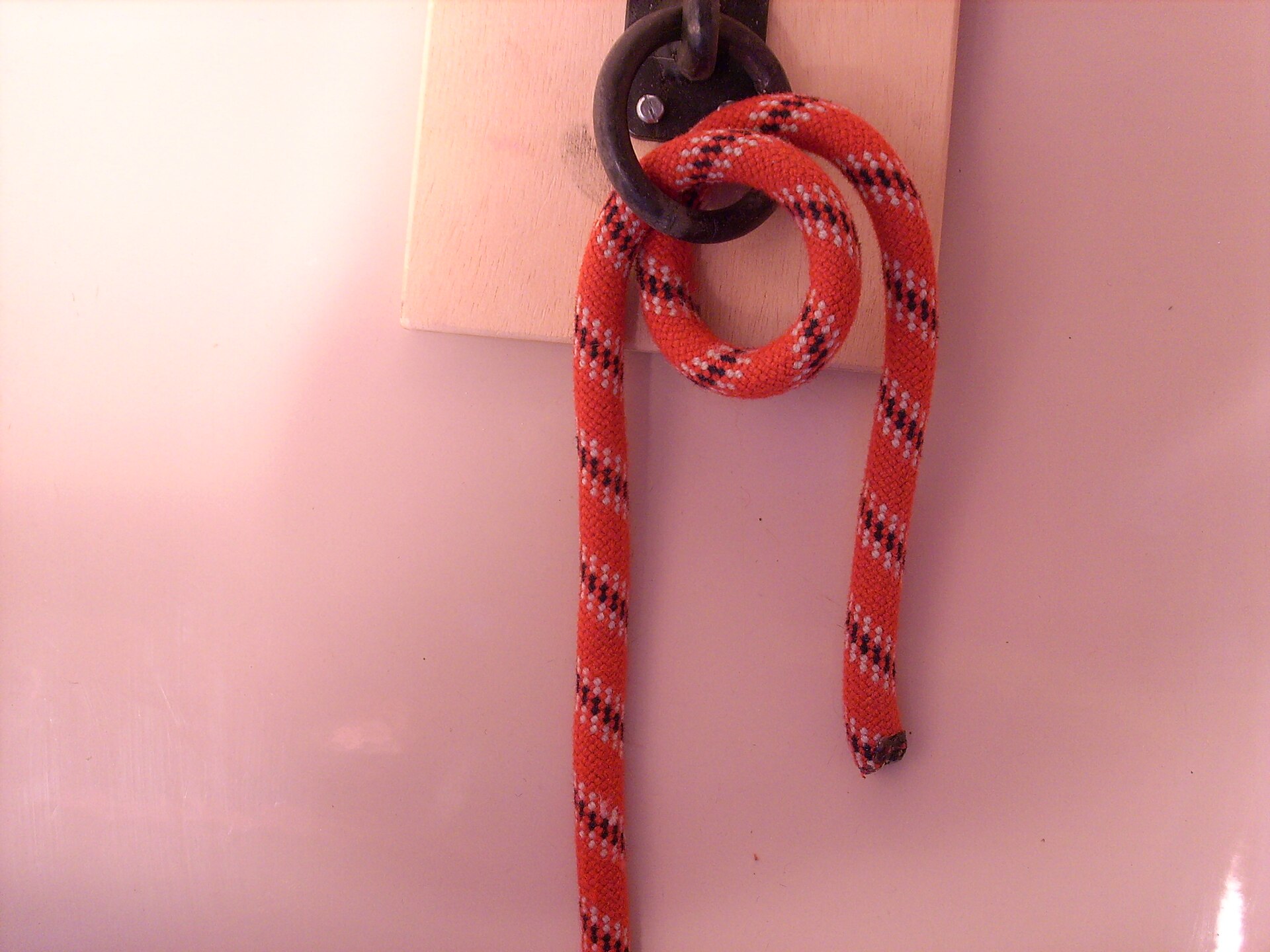 Red rope taking a round turn through a ring