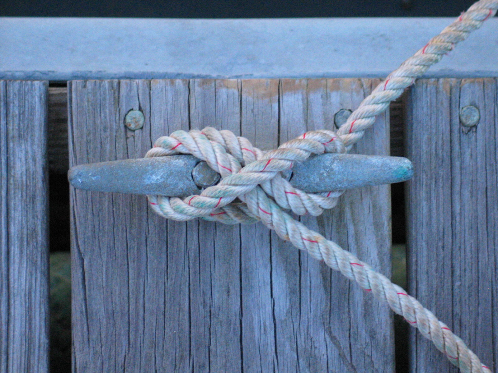 A completed cleat hitch on a pontoon cleat, with a turn around the base, figure-of-eight crossings and a locking hitch