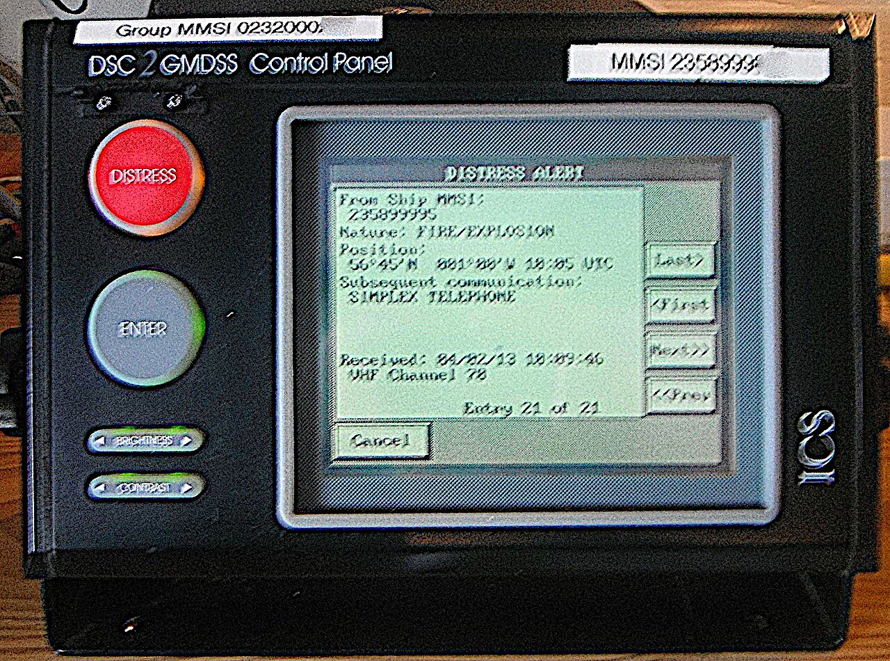 A DSC controller with the red DISTRESS button and a received distress alert showing MMSI, nature, position and time