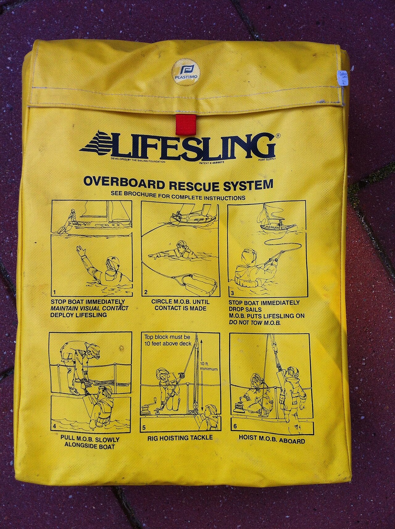 A Lifesling overboard rescue system stowed on the pushpit of a yacht: the horse-collar sling is attached to a long floating line