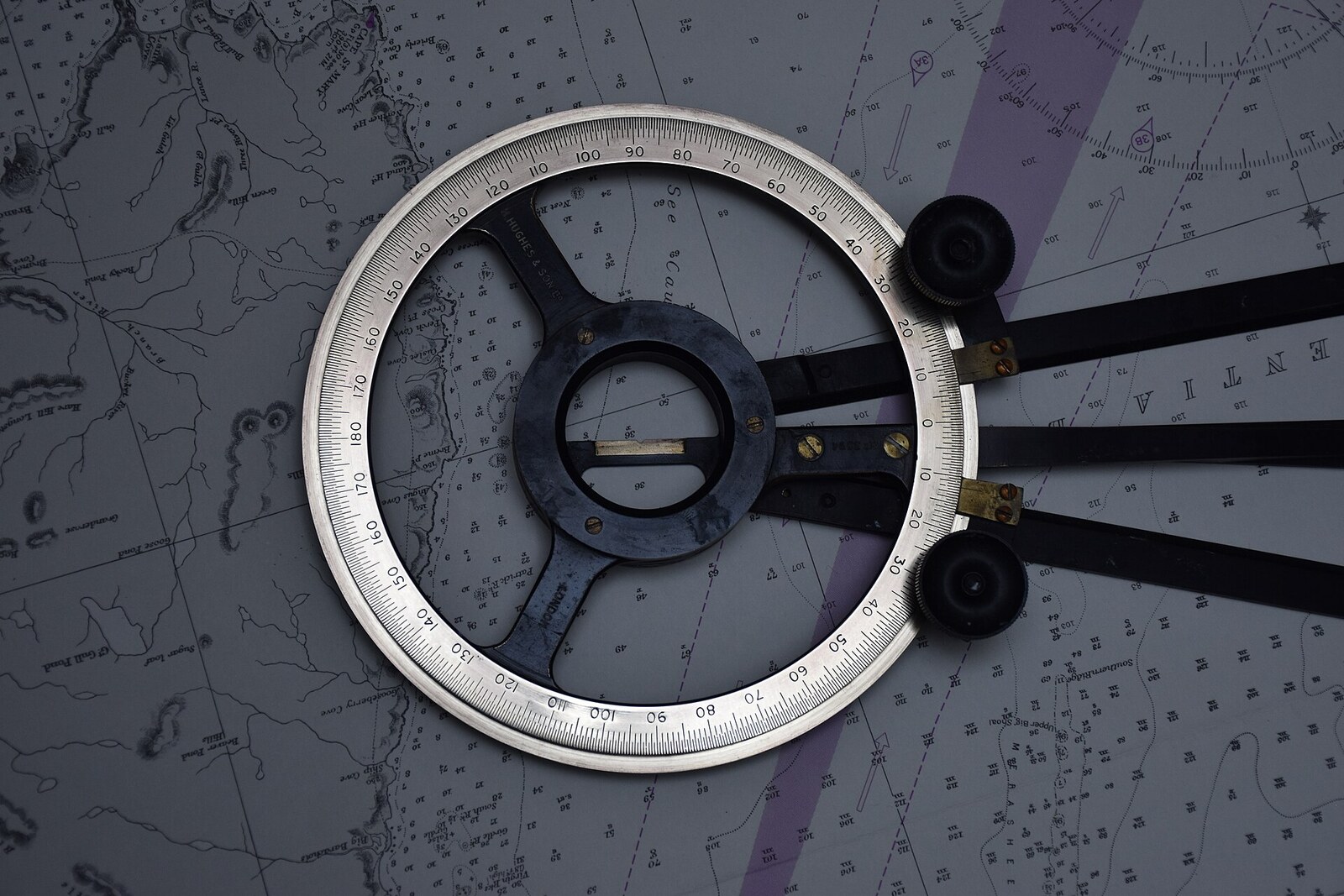 A station pointer: a protractor with three arms used to plot horizontal sextant angles