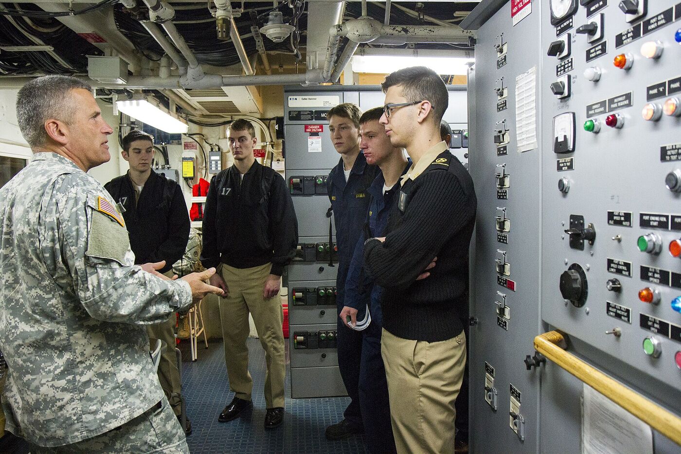 Kings Point midshipmen learning in a ship's engine control space